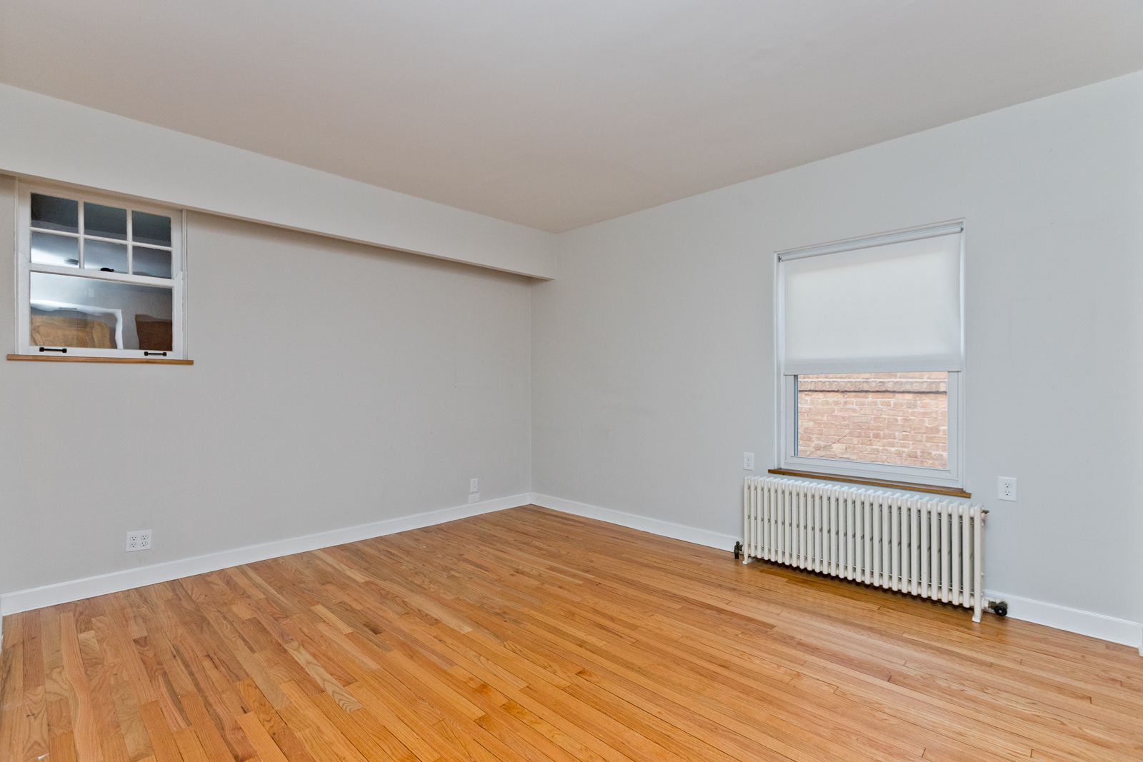 2950 Central Street, Unit 2 Evanston, IL 60201 - Photo 4 of 17 a view of empty room with wooden floor and fan