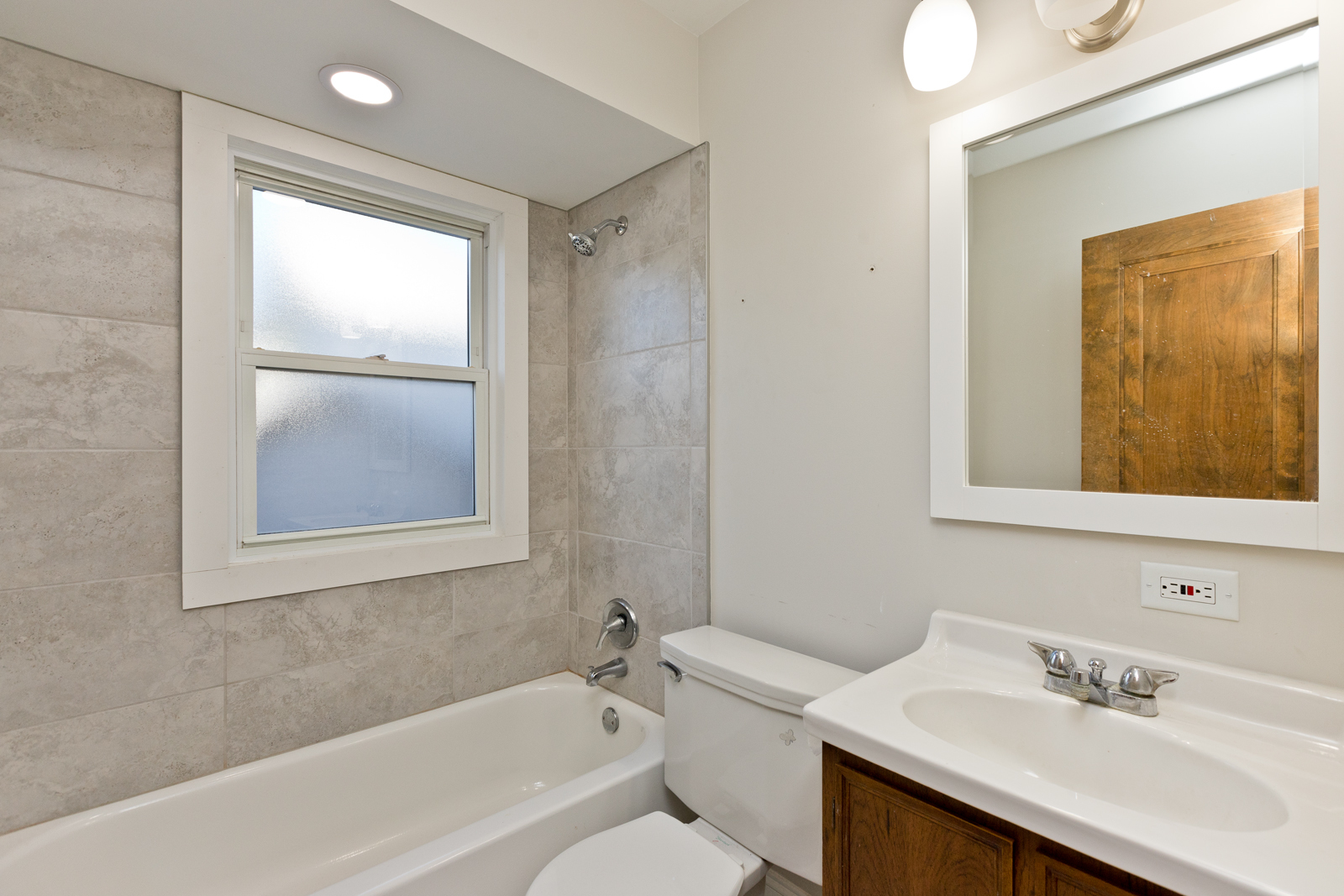2950 Central Street, Unit 2 Evanston, IL 60201 - Photo 8 of 17 a bathroom with a bathtub shower sink vanity and toilet