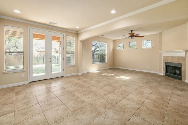 a view of an empty room with a fireplace and a window