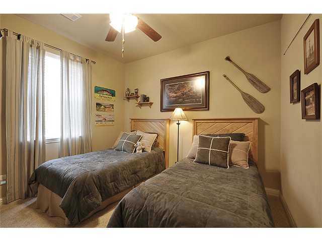 3313 Pine Needle Circle Round Rock, TX 78681 - Photo 8 of 12 a bedroom with a bed and a flat screen tv