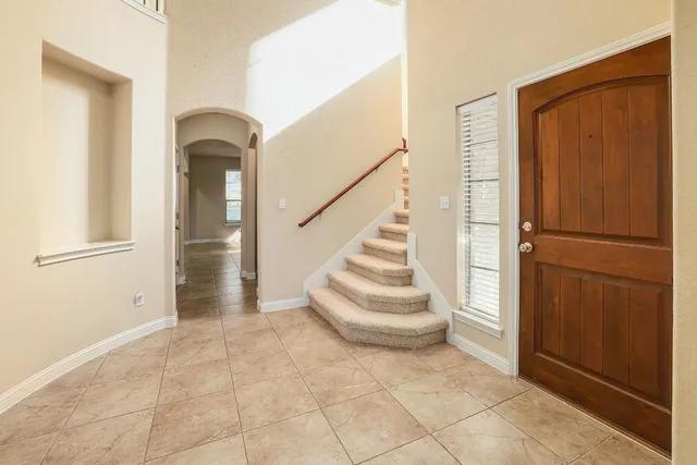 a view of entryway and hall with a door