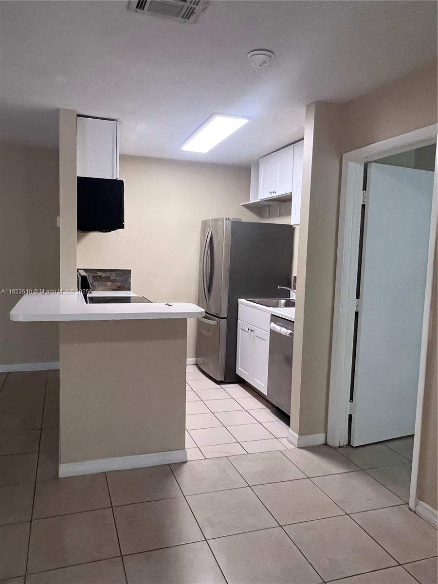 Crossings of Boynton Beach Condominiums Boynton Beach, FL 33435 - Photo 5 of 24 a kitchen with stainless steel appliances a refrigerator sink and microwave