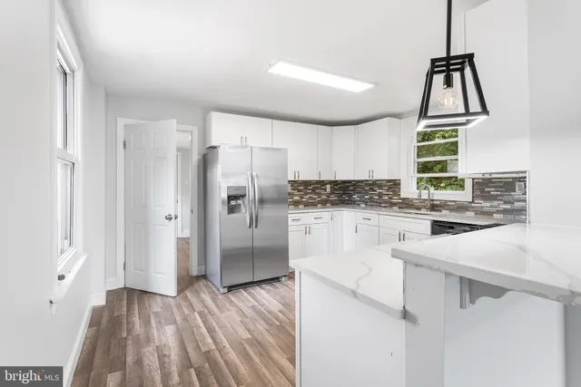 a kitchen with white cabinets and white appliances