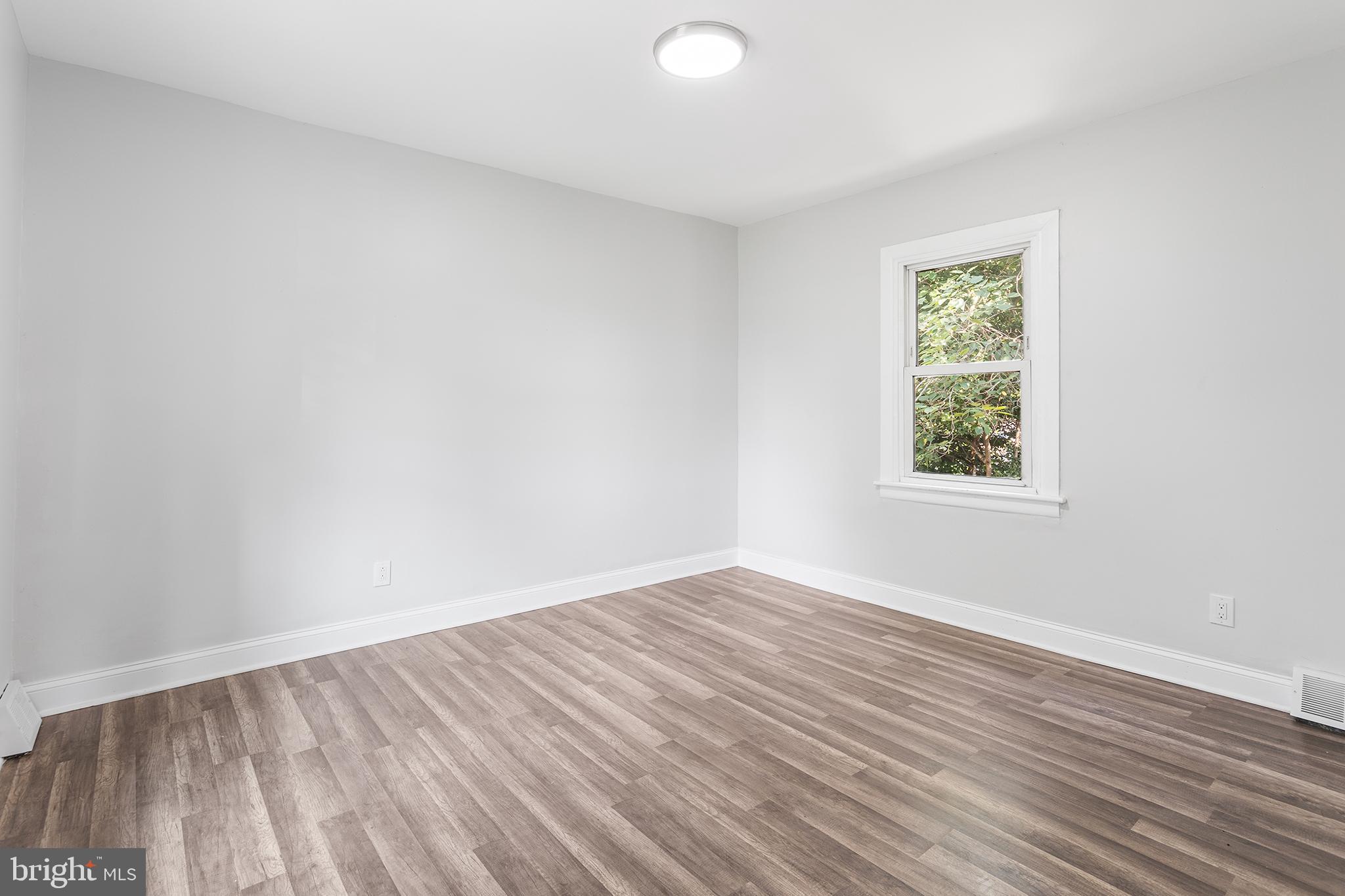 623 West 3rd Street Florence, NJ 08518 - Photo 21 of 36 an empty room with wooden floor and windows