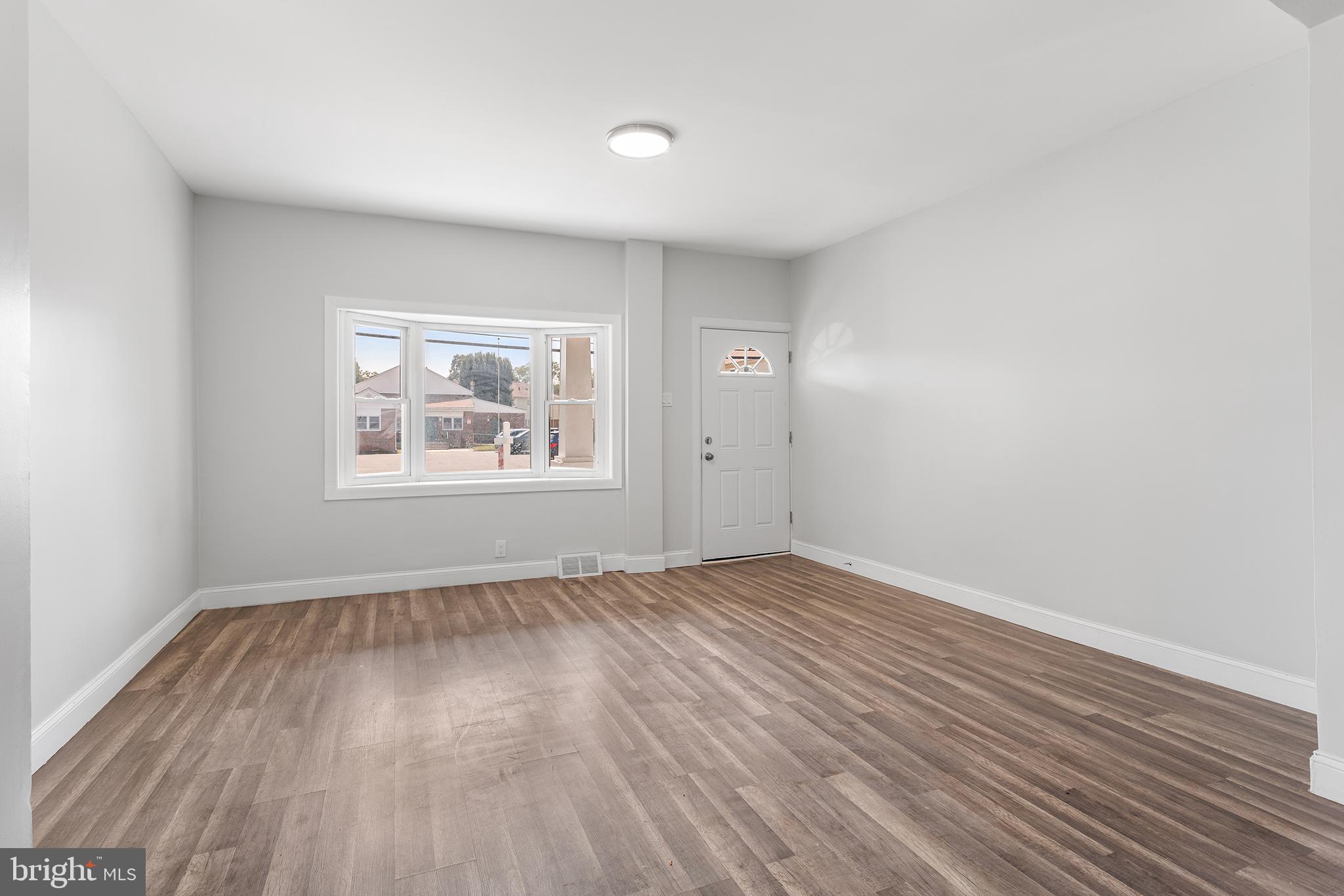 623 West 3rd Street Florence, NJ 08518 - Photo 7 of 36 an empty room with wooden floor and windows