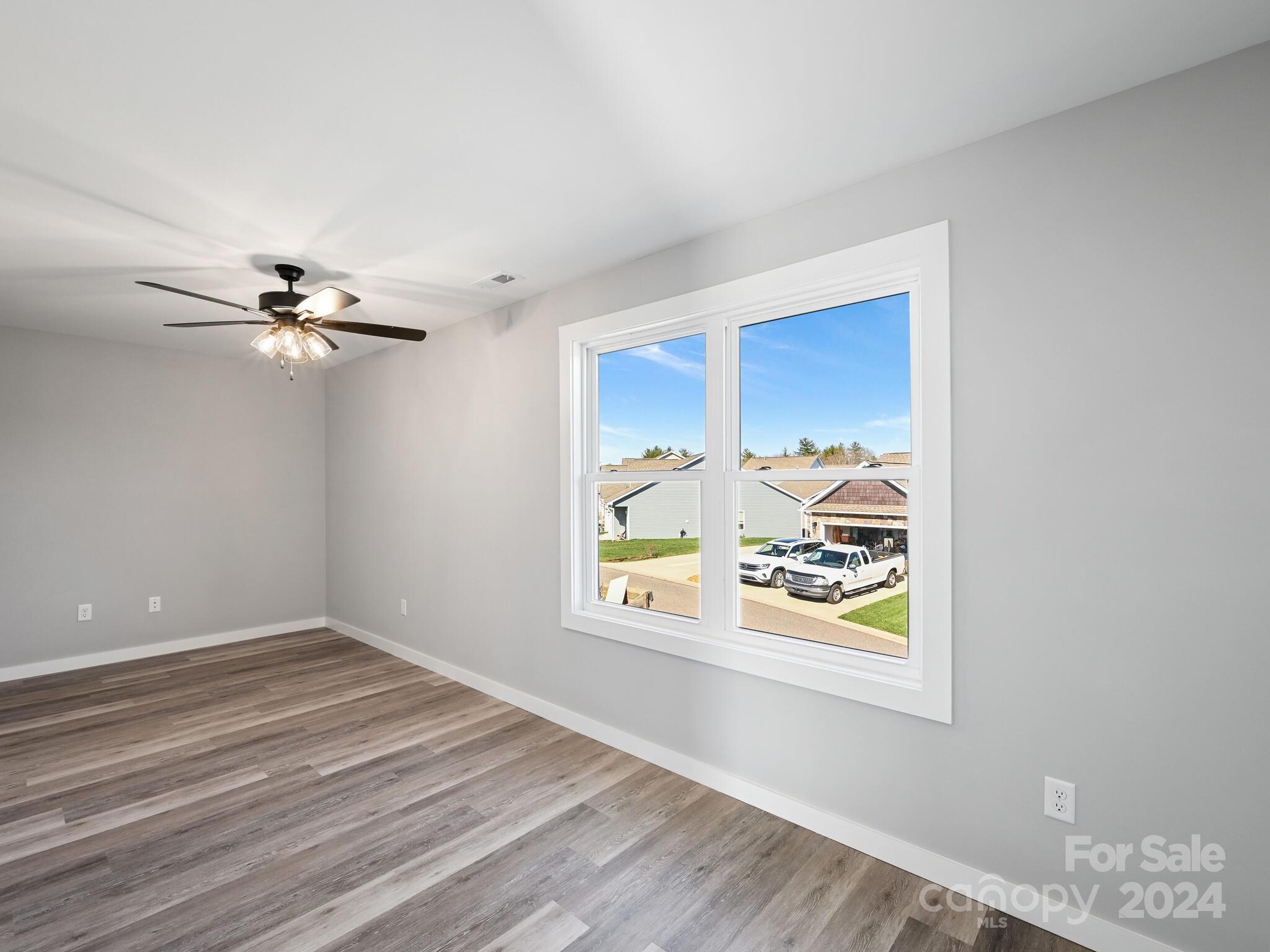37 Sage Crest Loop Weaverville, NC 28787 - Photo 14 of 33 a view of an empty room with window and wooden floor