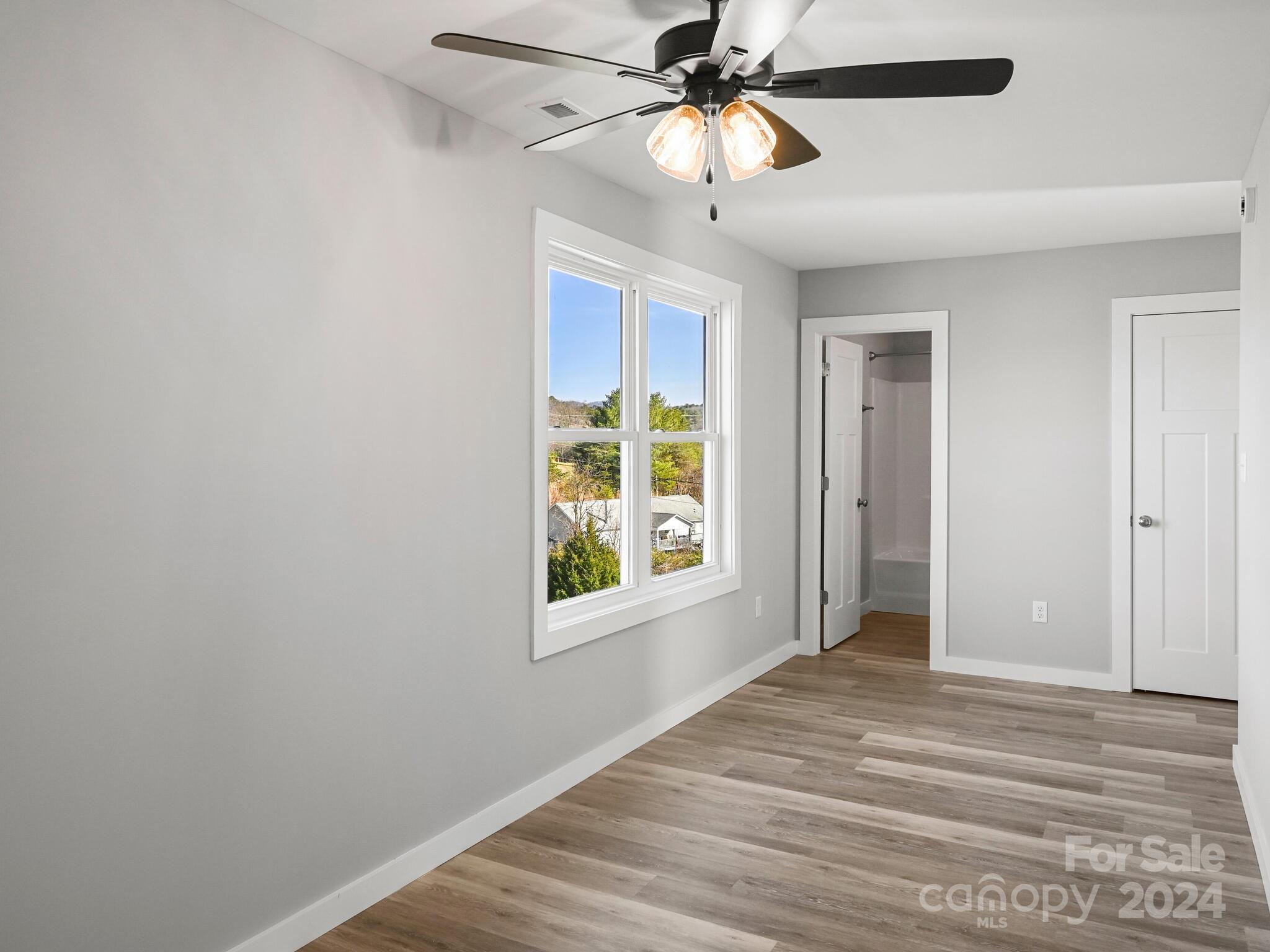 37 Sage Crest Loop Weaverville, NC 28787 - Photo 15 of 33 a view of an empty room with window and a ceiling fan
