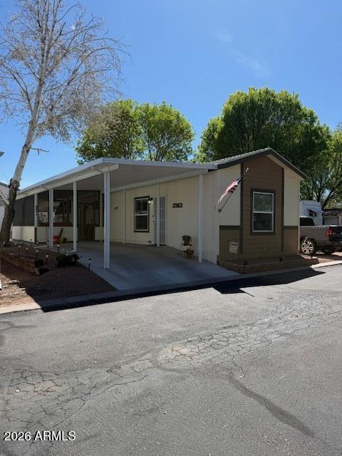 3933 Highway 260, Unit 242 Payson, AZ 85541 - Photo 1 of 30 a front view of a house with a yard and garage