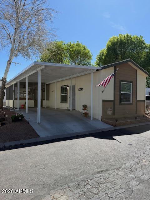 3933 Highway 260, Unit 242 Payson, AZ 85541 - Photo 29 of 30 a front view of a house with a yard and garage