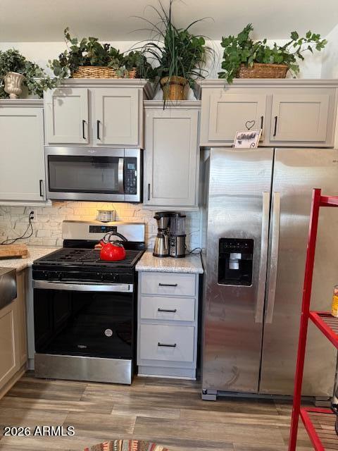 3933 Highway 260, Unit 242 Payson, AZ 85541 - Photo 5 of 30 a kitchen with stainless steel appliances granite countertop a stove a microwave and a refrigerator