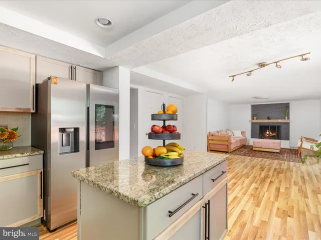 a kitchen with sink refrigerator and microwave