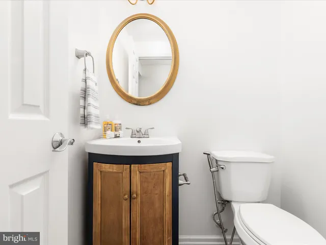 a bathroom with a toilet a sink and a mirror