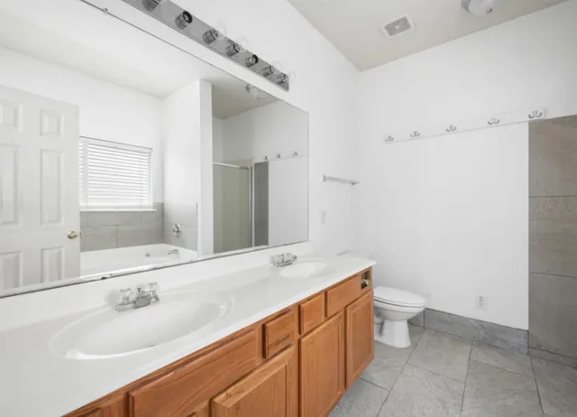 a bathroom with a sink a toilet and a mirror