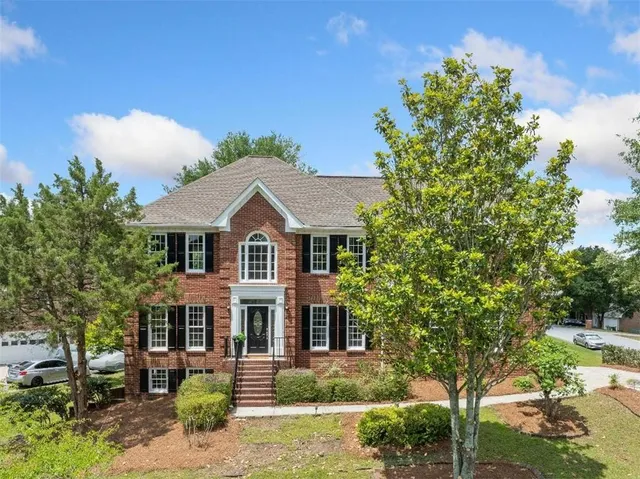 a front view of a house with a garden
