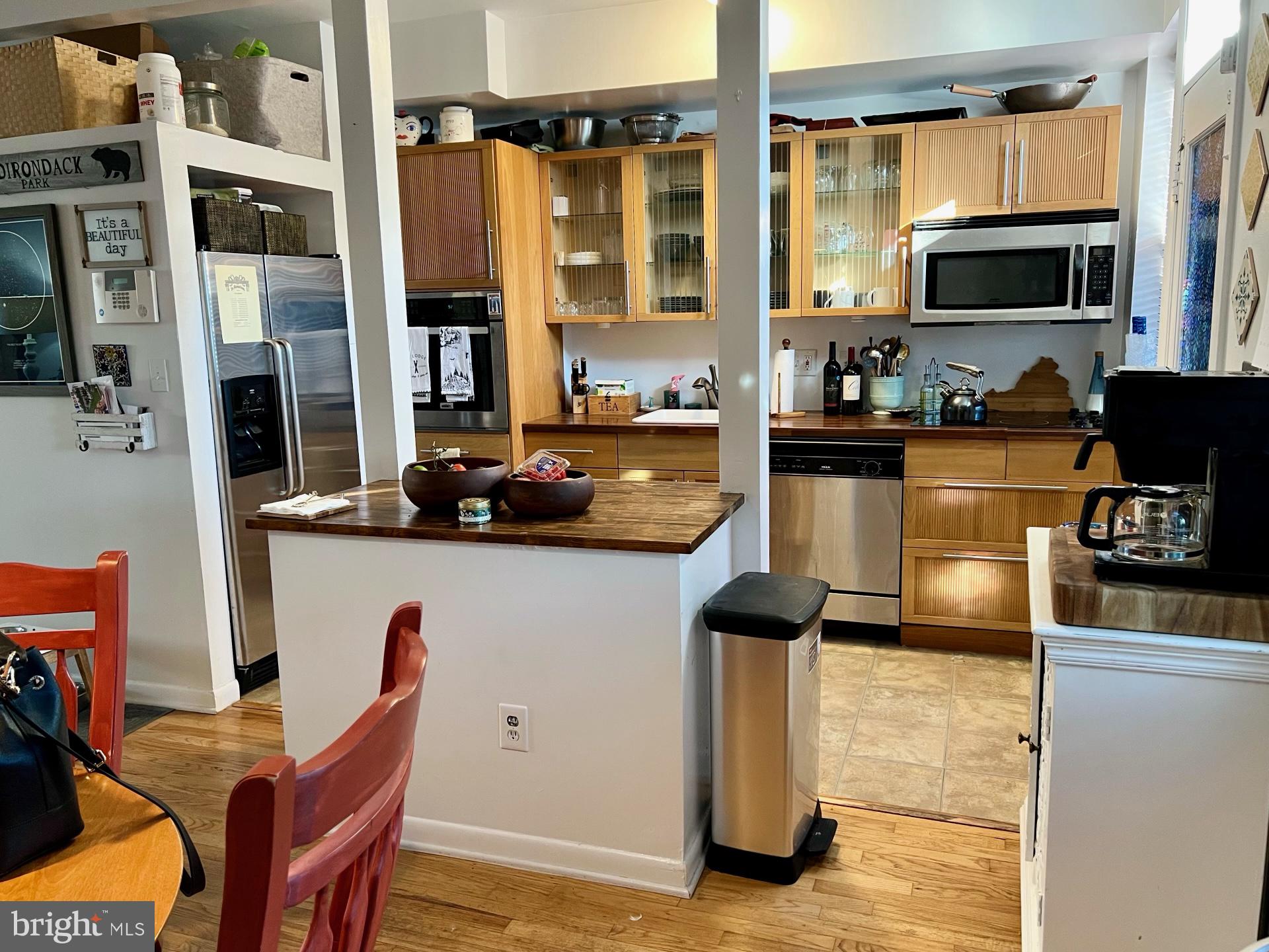 439 15th Street Northeast Washington, DC 20002 - Photo 8 of 17 a kitchen with a refrigerator and a stove top open
