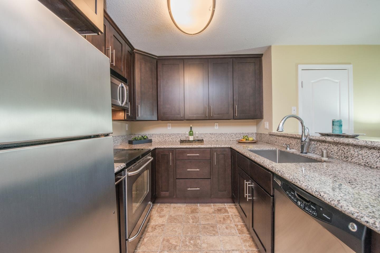 492 Dempsey Road, Unit 193 Milpitas, CA 95035 - Photo 13 of 35 a kitchen with a sink stove and cabinets