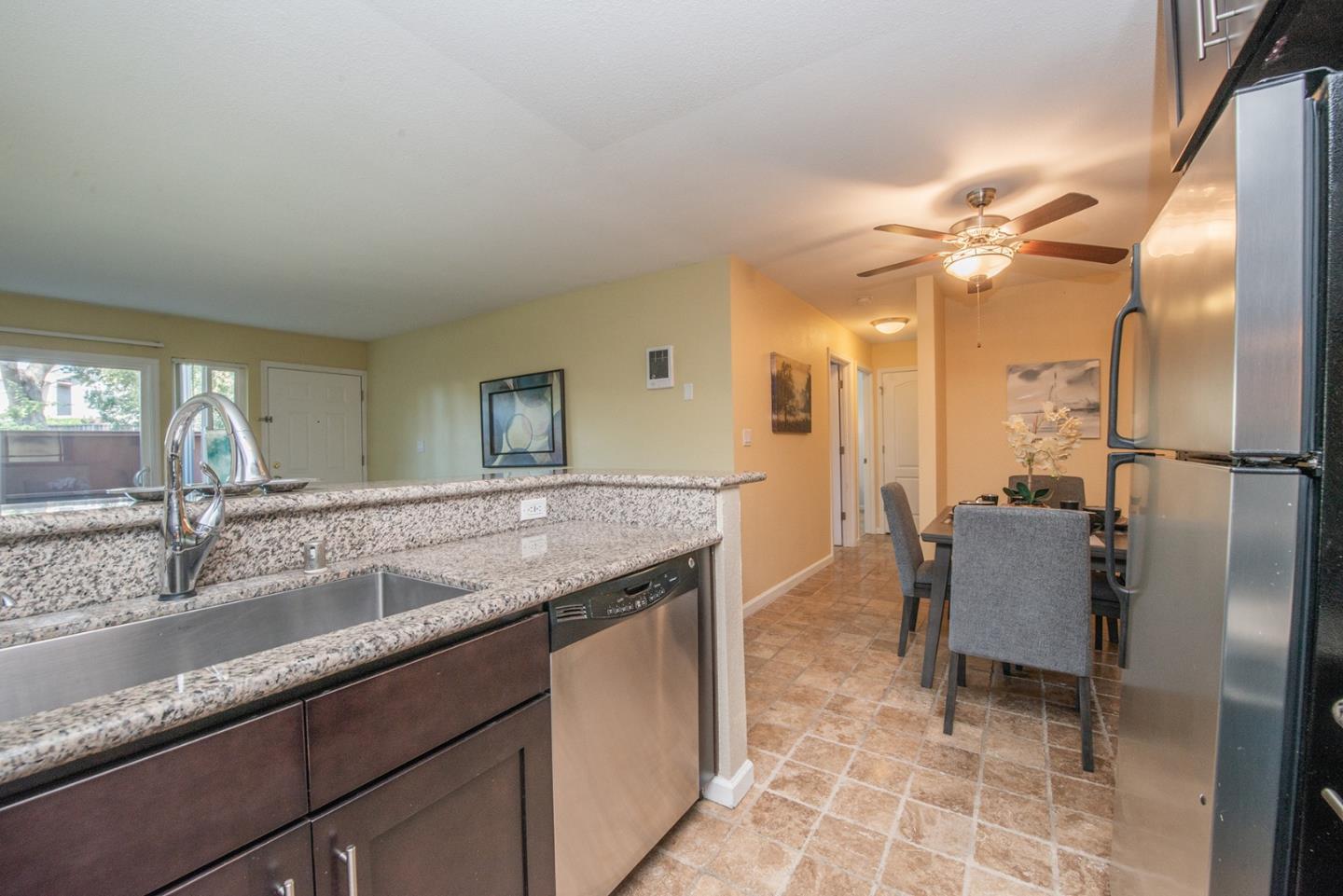 492 Dempsey Road, Unit 193 Milpitas, CA 95035 - Photo 15 of 35 a bathroom with a granite countertop sink a toilet and a mirror
