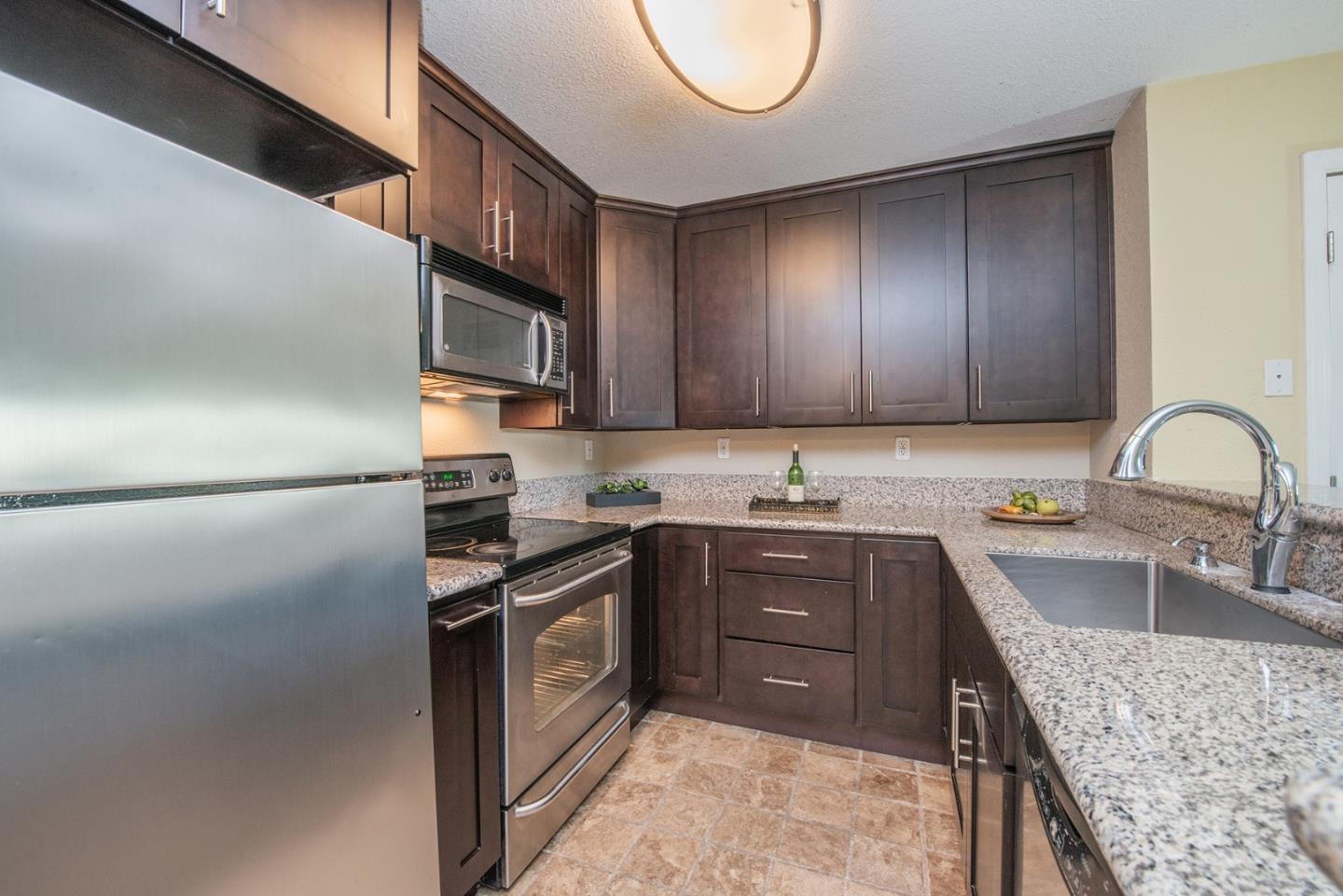 492 Dempsey Road, Unit 193 Milpitas, CA 95035 - Photo 16 of 35 a kitchen with stainless steel appliances granite countertop a sink stove and refrigerator
