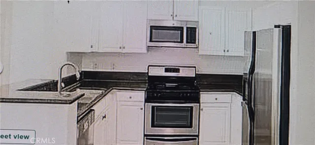 a kitchen with stainless steel appliances a stove and a refrigerator