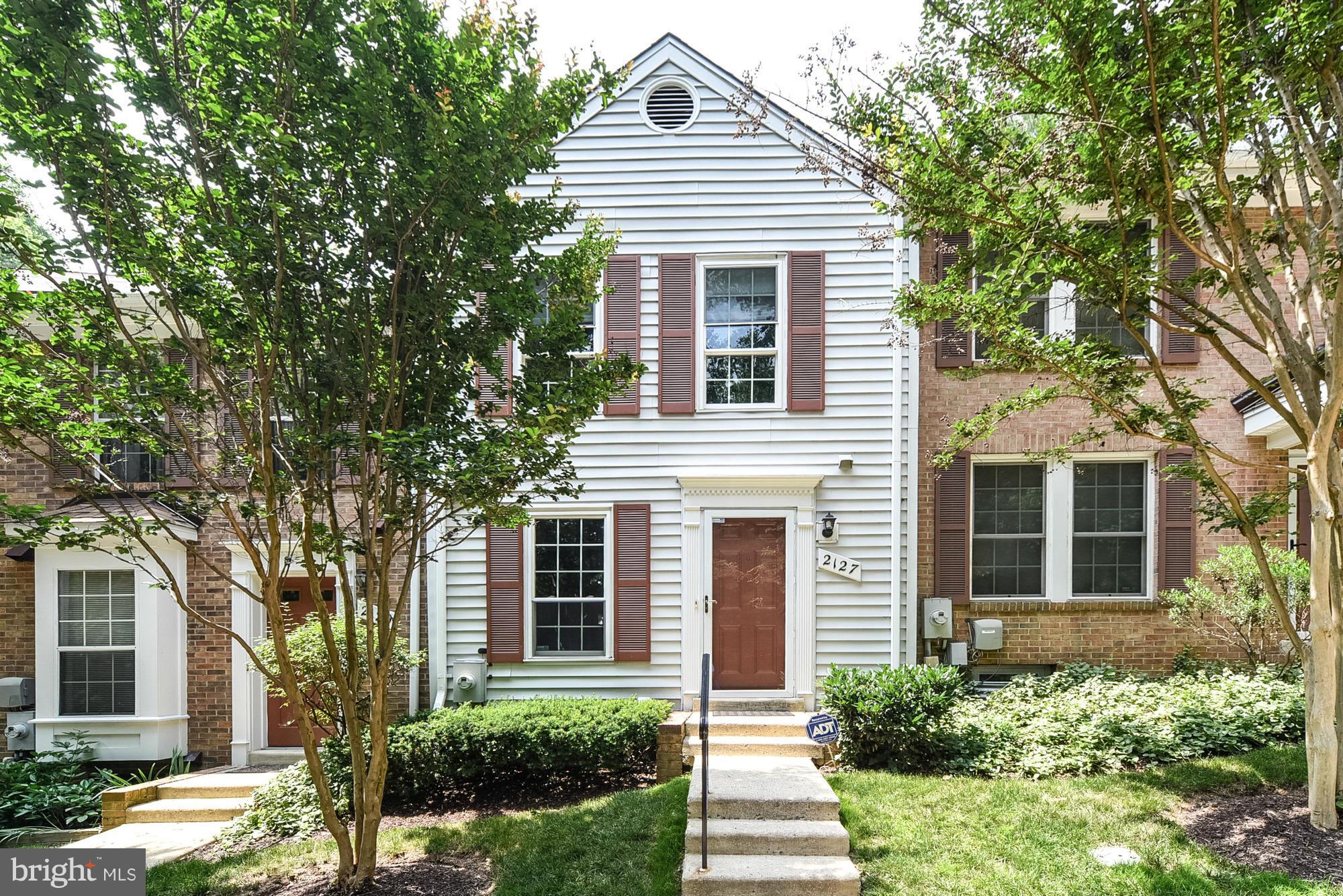 2127 Derby Ridge Lane, Unit 15 Silver Spring, MD 20910 - Photo 1 of 1 a front view of a house with a yard