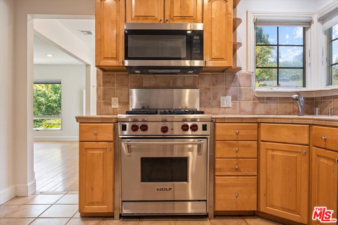 14041 Roblar Road Sherman Oaks, CA 91423 - Photo 14 of 47 a kitchen with a stove and a microwave