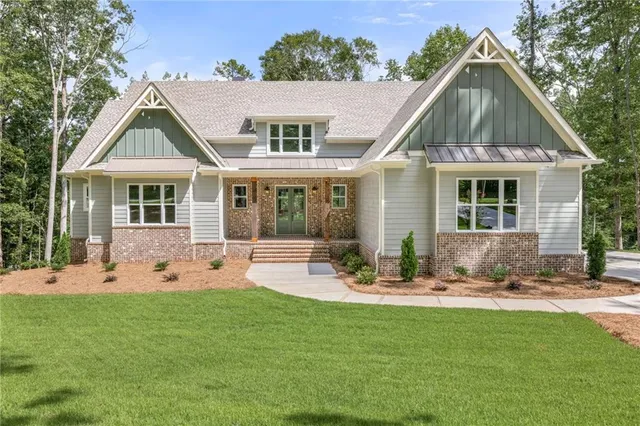 a front view of house with yard outdoor seating and green space