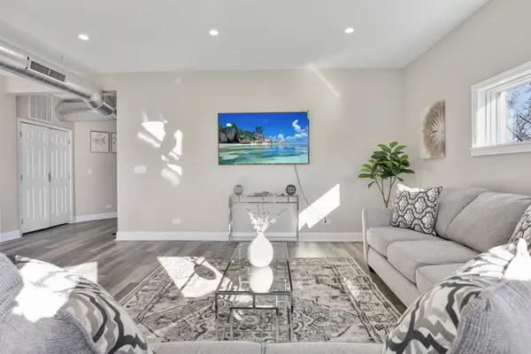 a living room with furniture and a painting on the wall