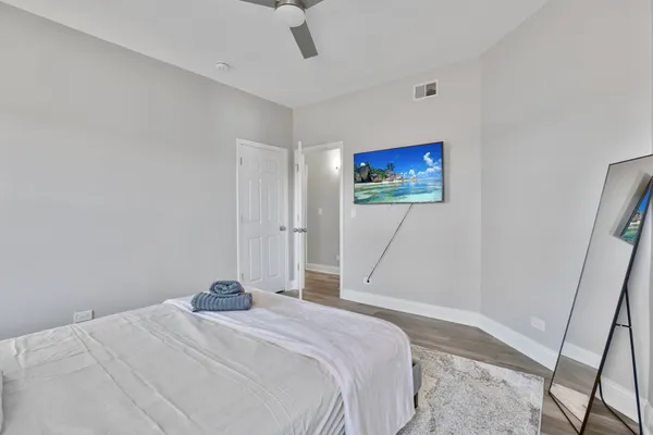 a bedroom with a bed and a painting on the wall