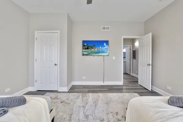 a bedroom with a bed and a painting on the wall