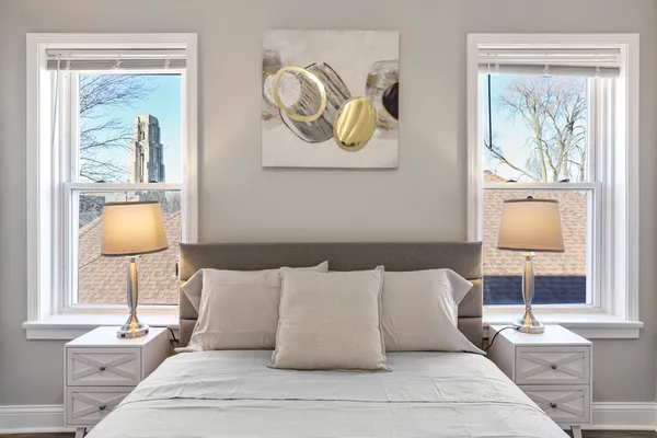 a bed room with a bed and painting on the wall