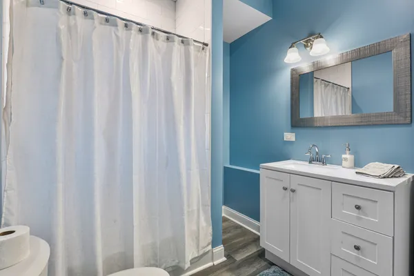 a bathroom with a double vanity sink and a mirror