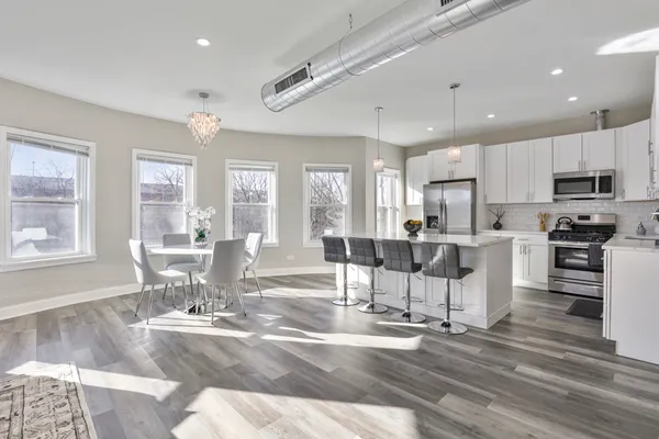 a living room with furniture and kitchen view