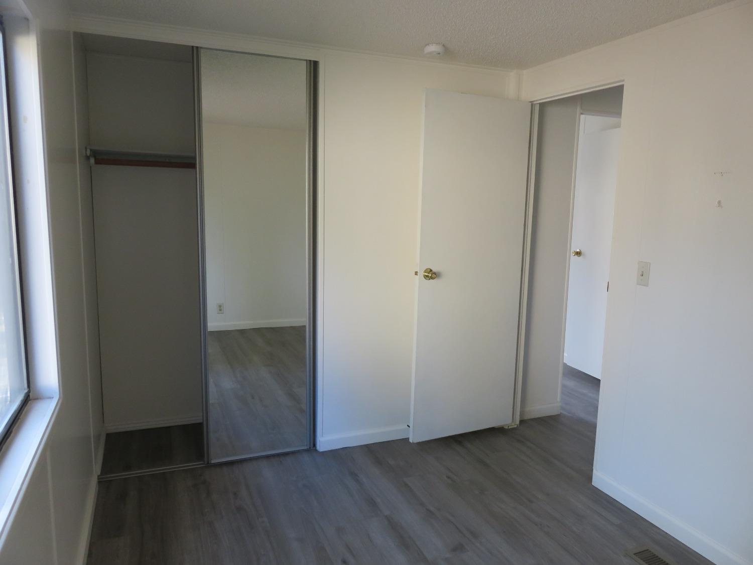 4426 Bald Mountain Road West Point, CA 95255 - Photo 21 of 45 an empty room with wooden floor and closet