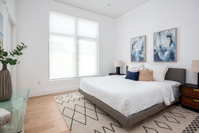 a bedroom with a large bed and a window