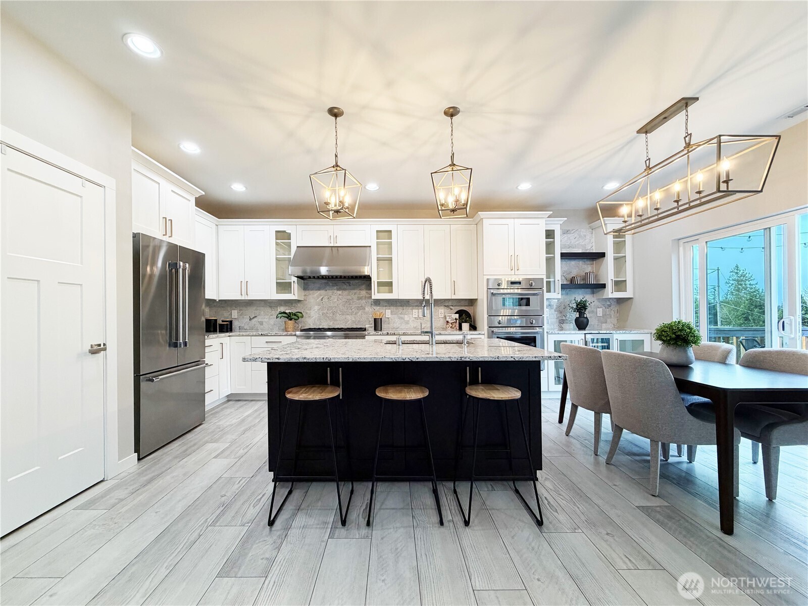 22724 41st Drive Southeast Bothell, WA 98021 - Photo 12 of 40 a kitchen with stainless steel appliances granite countertop a refrigerator a sink dishwasher a stove and white countertops with wooden floor