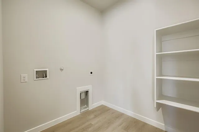 a view of a room with wooden floor