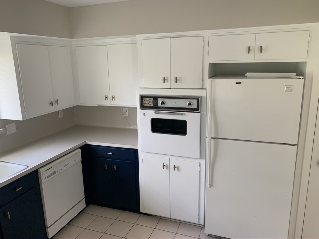29229 Sheffield Road Waller, TX 77484 - Photo 7 of 16 Kitchen is light and bright with navy blue bottom cabinets to bring in the perfect contrast.