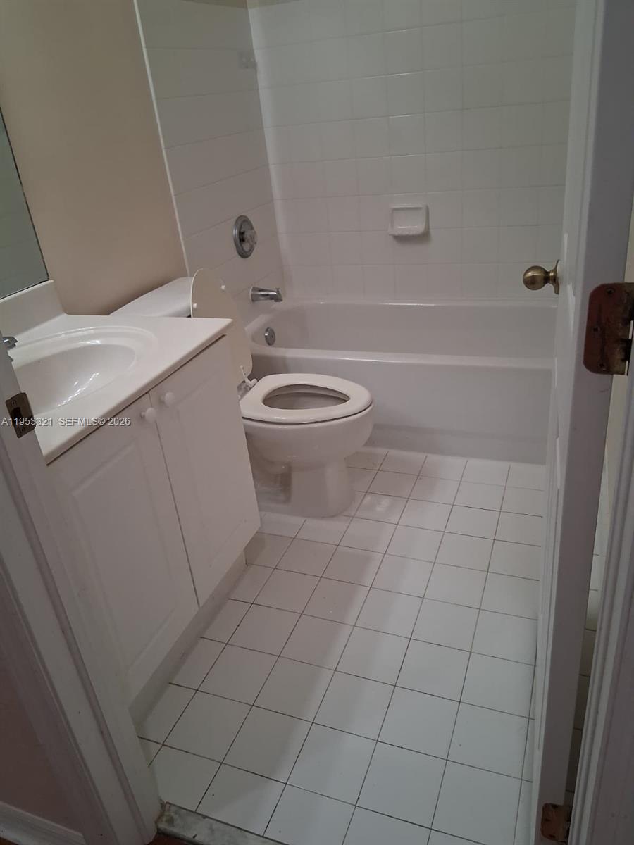3395 Merrick Court, Unit 1110 Margate, FL 33063 - Photo 12 of 16 a bathroom with a sink a toilet and shower
