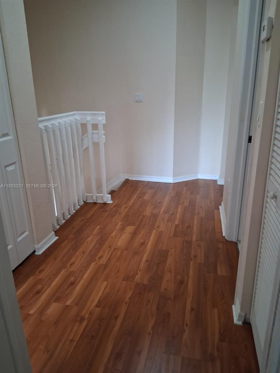 3395 Merrick Court, Unit 1110 Margate, FL 33063 - Photo 13 of 16 a view of empty room with wooden floor