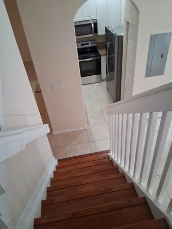 a view of entryway and hall with wooden floor