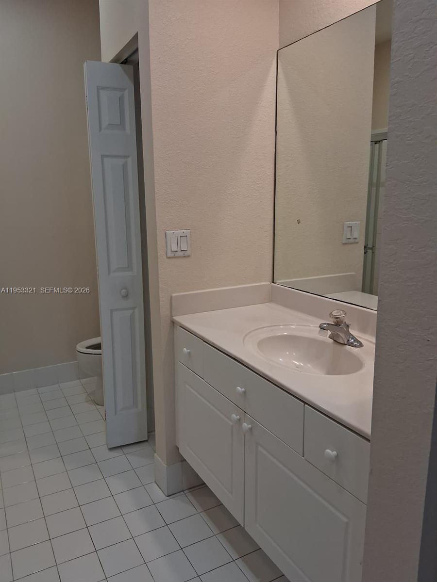3395 Merrick Court, Unit 1110 Margate, FL 33063 - Photo 8 of 16 a bathroom with a sink and a mirror