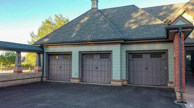 426 West Center Street Parowan, UT 84761 - Photo 7 of 107 Three-car garage featuring carriage-style doors with decorative hardware and upper window panels