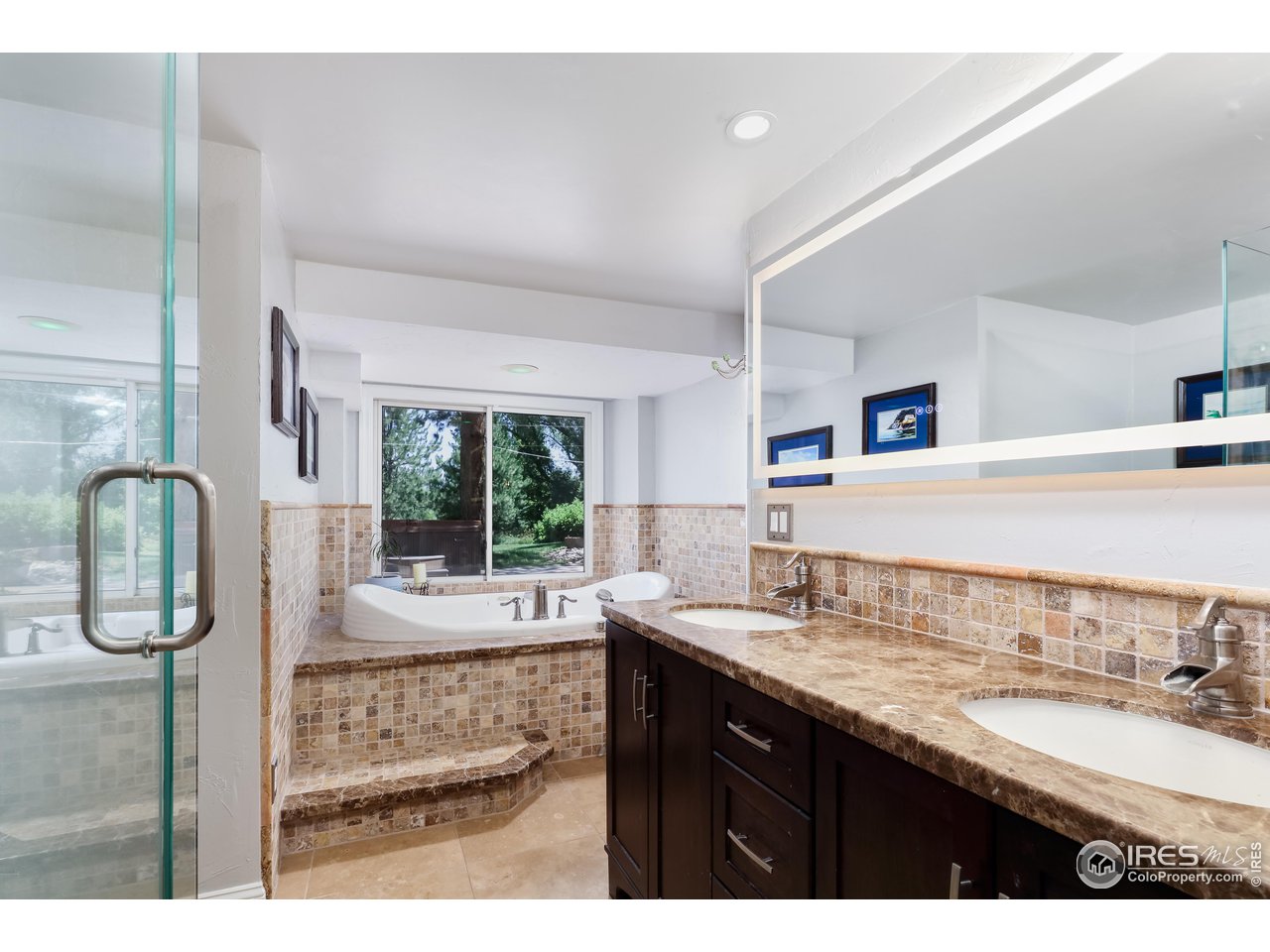 5825 Rustic Knolls Drive Boulder, CO 80301 - Photo 21 of 40 a bathroom with a granite countertop sink and a mirror