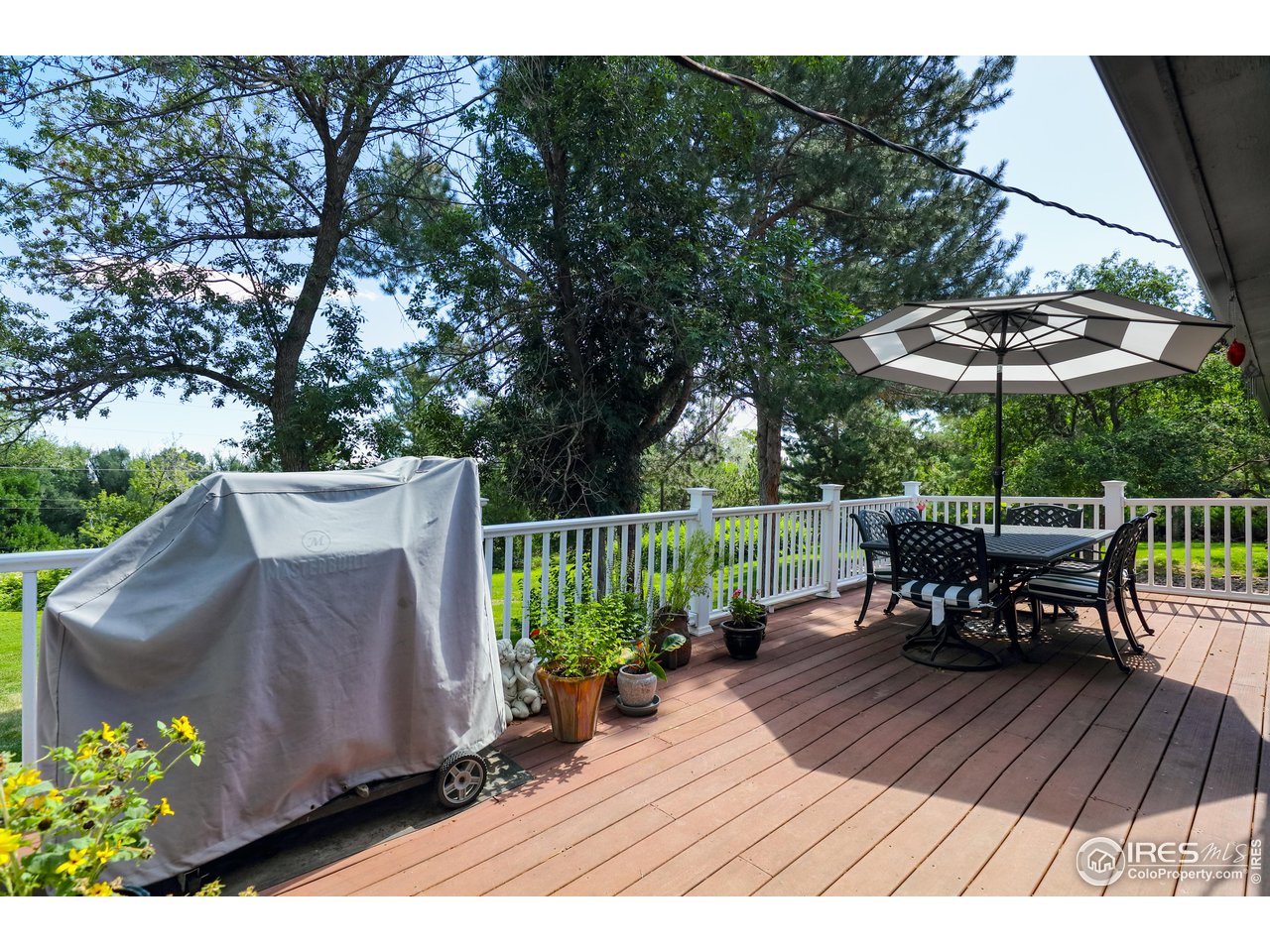 5825 Rustic Knolls Drive Boulder, CO 80301 - Photo 6 of 40 a view of a chairs and table on the wooden roof deck