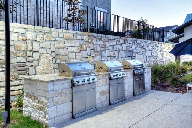 a barbeque stove top oven and cabinets