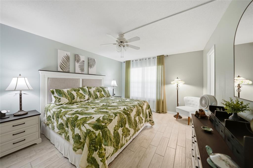 1 Colony Point Drive, Unit A10 Punta Gorda, FL 33950 - Photo 21 of 31 a bed room with a bed and a lamp