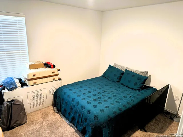 a bedroom with a bed and dresser