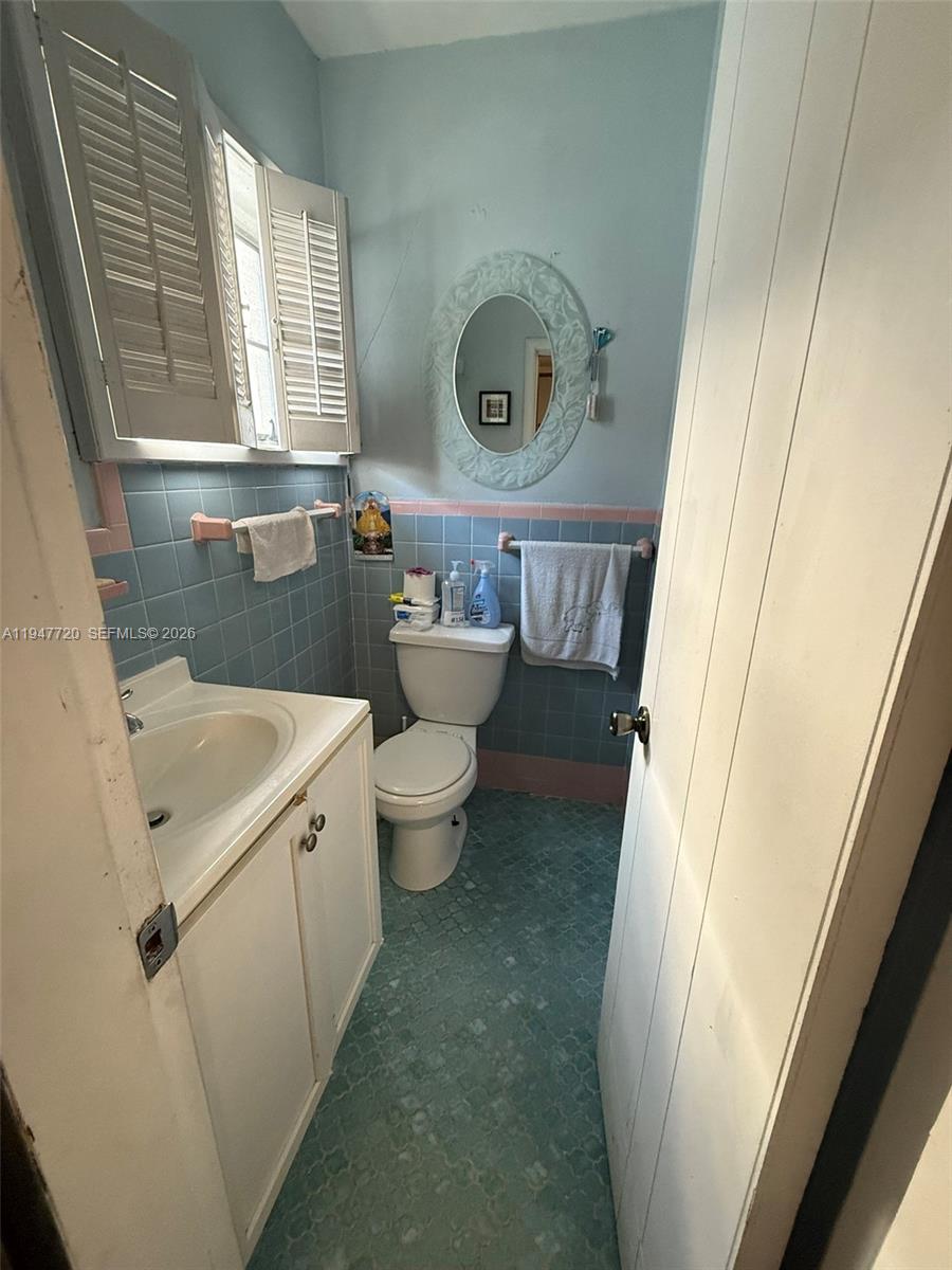 2560 Southwest 22nd Avenue Miami, FL 33133 - Photo 4 of 15 a bathroom with a sink a toilet and a window