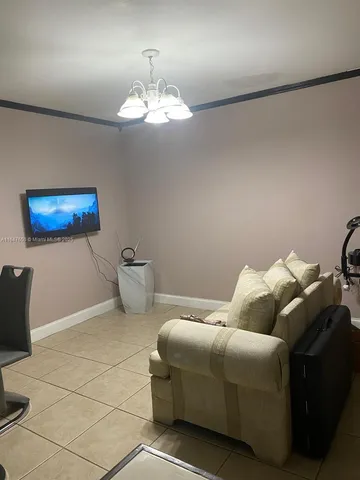 a bed room with a bed and a chandelier