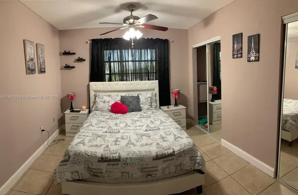 a bed room with a bed and a chandelier